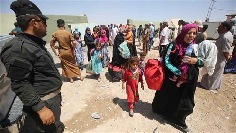 Yezidi Women, Men and Children entering an IDP Camp